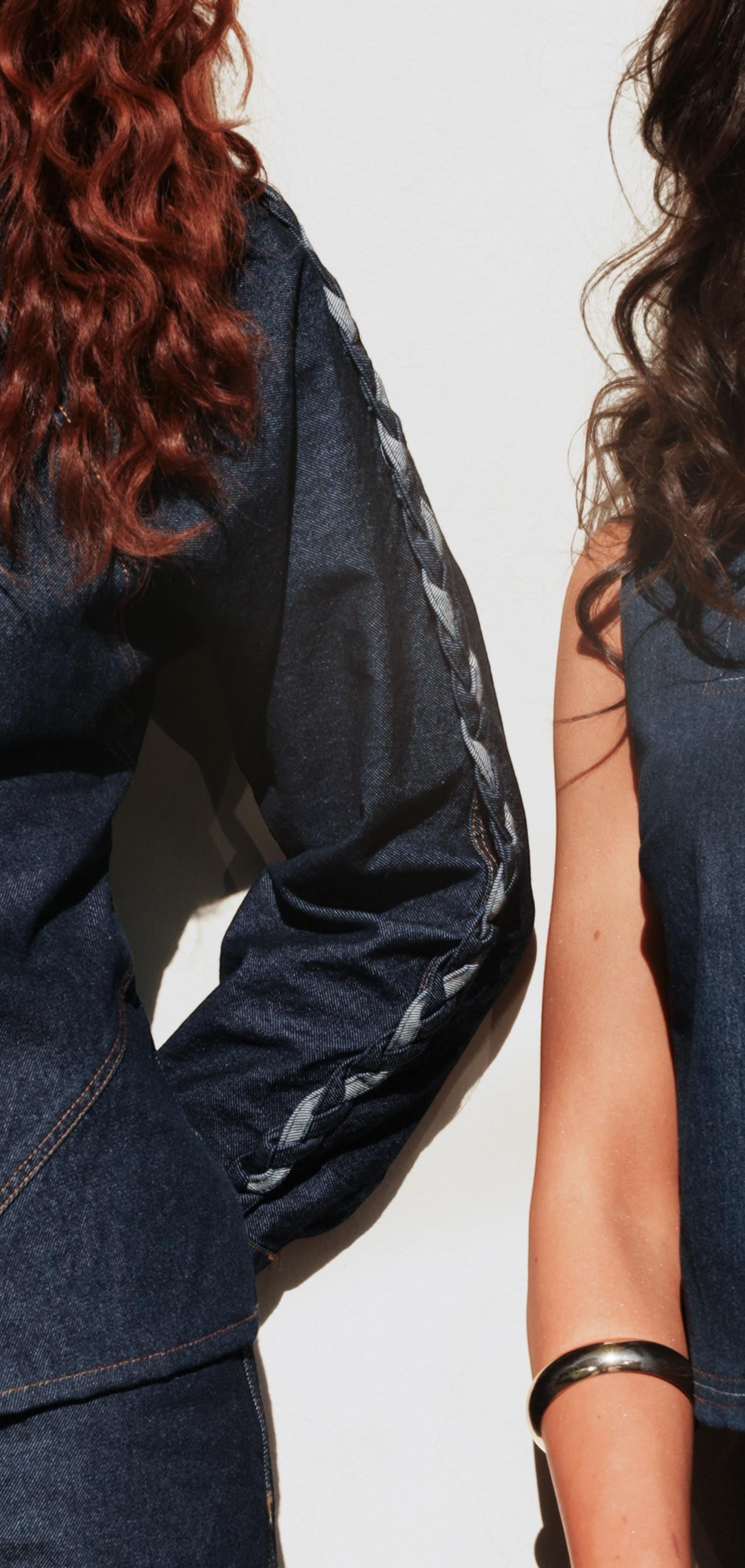 shorouqmazrawi indigo denim shirt featuring hand-braided contrast trim along the sleeve and shoulder