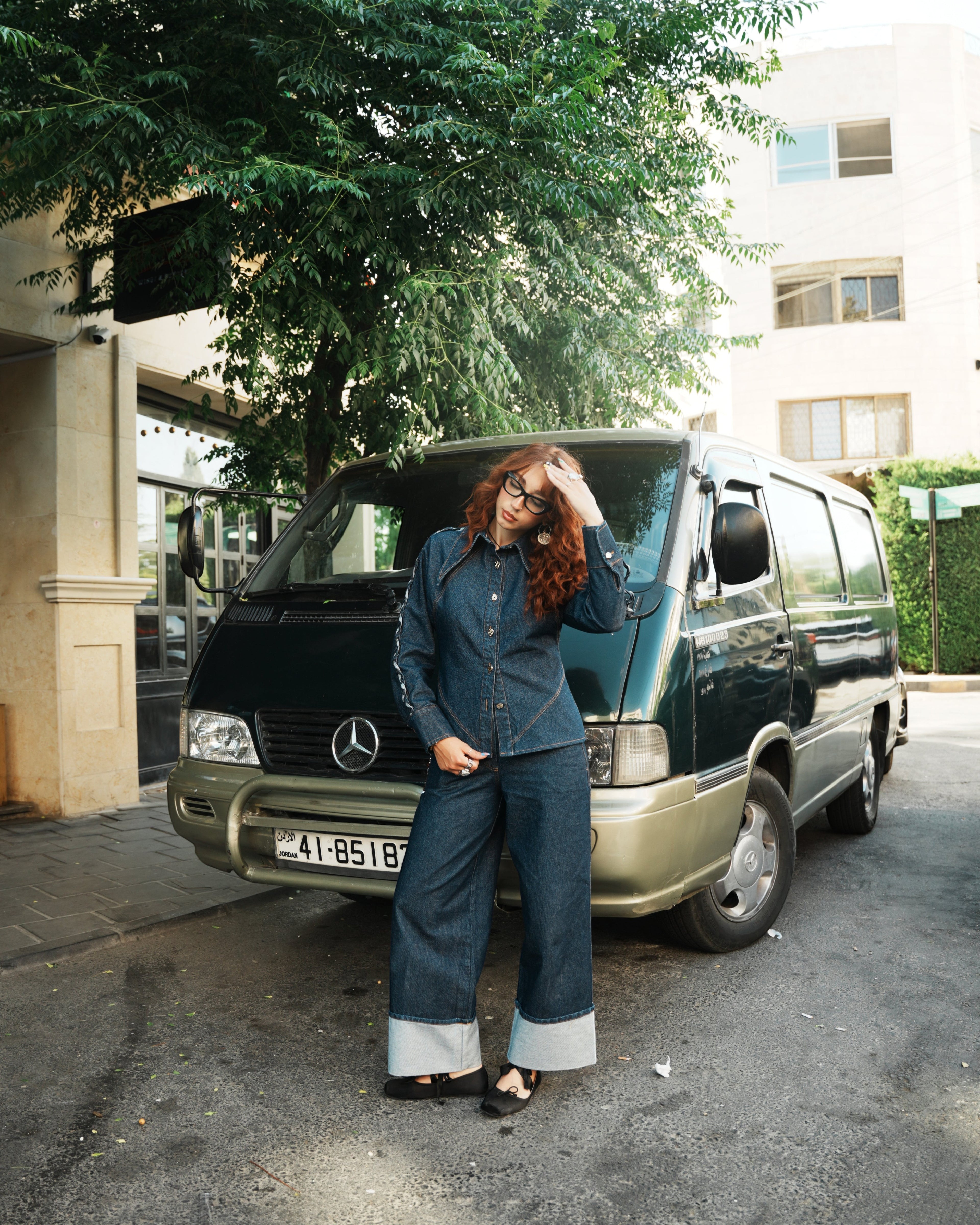 shorouqmazrawi wide-leg indigo denim pants with a 15cm cuffed hem, worn by a model with a matching denim shirt.